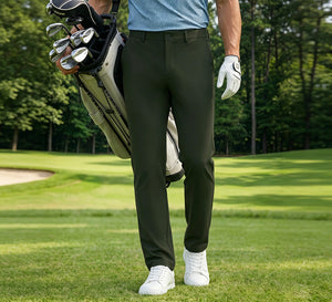 Golfer wearing Water Repellent Classic Fit Flat Front Golf Dress Pants walking on the golf course with a golf bag