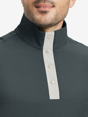 Close-up from nose to chest, highlighting buttoned collar and textured fabric of the dark grey pullover.
