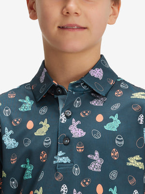 Close-up: nose to chest in easter bunny eggs performance print boys golf polo