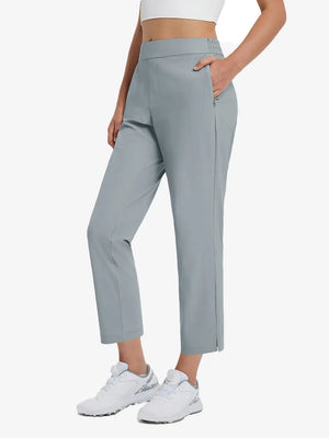 Front lower-body view of model with right hand in pocket wearing LIGHT GREY Women's 7/8 Ankle Golf Track Pants.