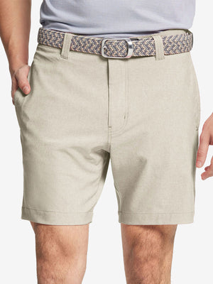Front view of youth wearing cream Heather Performance Golf Shorts, showing fit and style