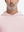 Close-up from nose to chest, showing soft collar texture and stitching detail of the light pink hoodie.