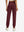 Model wearing women's stretch fleece lined water resistant joggers in wine, showing the back lower body view.