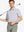 Front half-body shot holding golf club in Lavender White Yarn Dyed Stripe Polo – fresh and refined