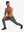Model performing lunges in soft sweatpants with 4 zipper pockets black heather