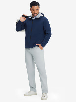 Full-body shot of model holding a golf bag while wearing light gray thermal water repellent fleece dress pants