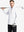 Full-body shot of model holding a golf club in white moisture wicking quarter zip pullover