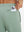 Close-up of iPhone partly inside pocket of beryl green soft sweatpants with 4 zipper pockets