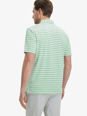 Back view of model in Fruit Green Navy Stripe Performance Stripe Golf Shirt