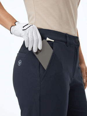 Detail view of front pocket on navy women's regular fit stretchy golf pants