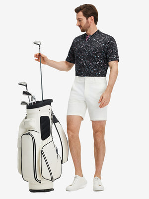 Full front: model in black splatter stretch printed collarless henley golf shirts holding golf club.