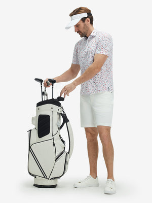 Full-body front view of model wearing the white polka dots 4 way stretch print collared polo shirt, showing the complete outfit