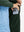 Close-up of the front side pocket detail on kids soft lightweight fleece lined jacket in forest green, showing quality stitching.