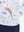 Model with both hands in pockets wearing youth full print stylish hoodies pullover in white cartoon toy.