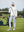 The model is wearing Women's Water-Resistant Stretch Fleece Lined Jacket beige on the golf course.