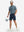 Full body model with cap holding golf bucket in Performance quick dry print golf polos, camo fragments