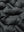 Fabric close-up of boys windproof puffer jacket with pockets, highlighting texture and finish in black.