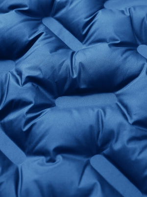 Fabric close-up of boys windproof puffer jacket with pockets, highlighting texture and finish in klein blue.