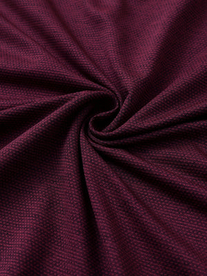 Close-up of burgundy ventilated heather jacquard polo fabric showing breathable texture and subtle pattern details.