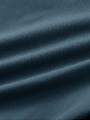 Close-up of fabric on water resistant everyday pants, showing texture and finish in dark teal.