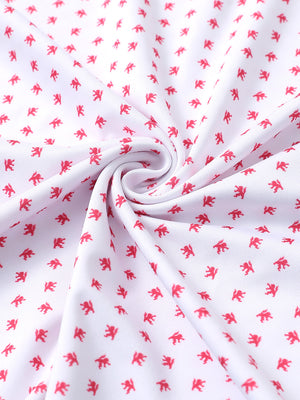 Close-up of white red lion performance jersey print polo fabric showing breathable texture and vibrant pattern details.