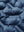 Fabric close-up of boys windproof puffer jacket with pockets, highlighting texture and finish in dark blue.