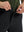 Detail view of the zipper on the black stretch soft flat front dress golf shorts, highlighting secure closure