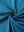 Close-up of dusty blue chest print polo shirt fabric showing smooth texture and crisp graphic application area.