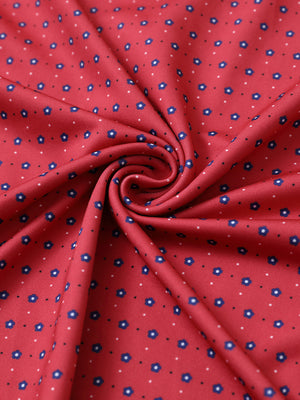 Close-up of red navy flower performance jersey print polo fabric showing breathable texture.