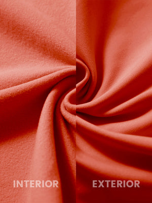 Close-up of the inner and outer fabric of kids soft lightweight fleece lined jacket in orange.
