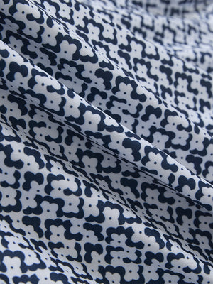 Fabric close-up of Performance quick dry print golf polos showing breathable texture in white navy clouds
