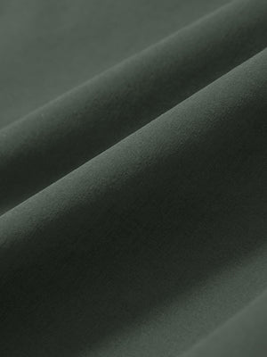 Macro view of the grey green stretch soft flat front dress golf shorts fabric, showcasing the smooth texture