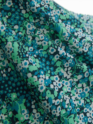 Fabric close-up of Performance quick dry print golf polos showing breathable texture in navy green floral