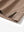 Close-up of the hem vent on the light brown ventilated pique performance polo, showing the side split for movement