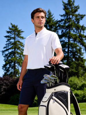 Outdoor shot of a model with a golf bag, wearing the white moisture-wicking short sleeve henley shirt with a relaxed fit
