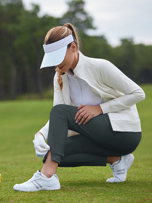 Woman adjusting ankle zip on Women's Ultra-stretch Quick Dry Sweatpants with Ankle Zips in dark grey on golf course