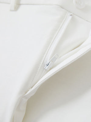 Detail view of the zipper on the white youth water resistant cotton blend golf pants, highlighting secure closure