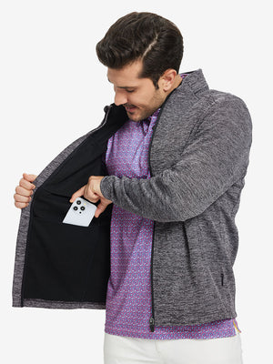 Model front half body lifting jacket, hand in inner pocket, textured insulated winter jacket, black heather.