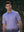 Model in lavender everyday classic solid polo standing outdoors, waist-up shot.