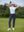 Woman wearing Women's Ultra-stretch Quick Dry Sweatpants with Ankle Zips in navy, holding golf club on course